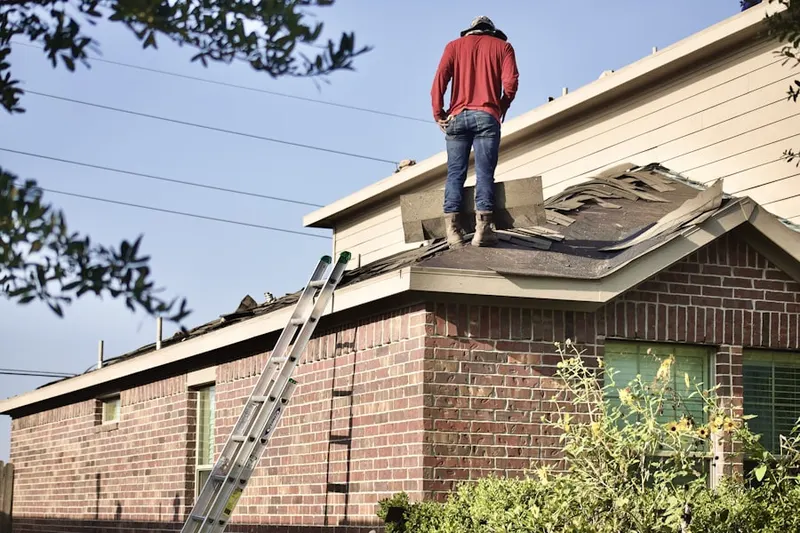 Professional roofer working on a residential roof in Justifiable